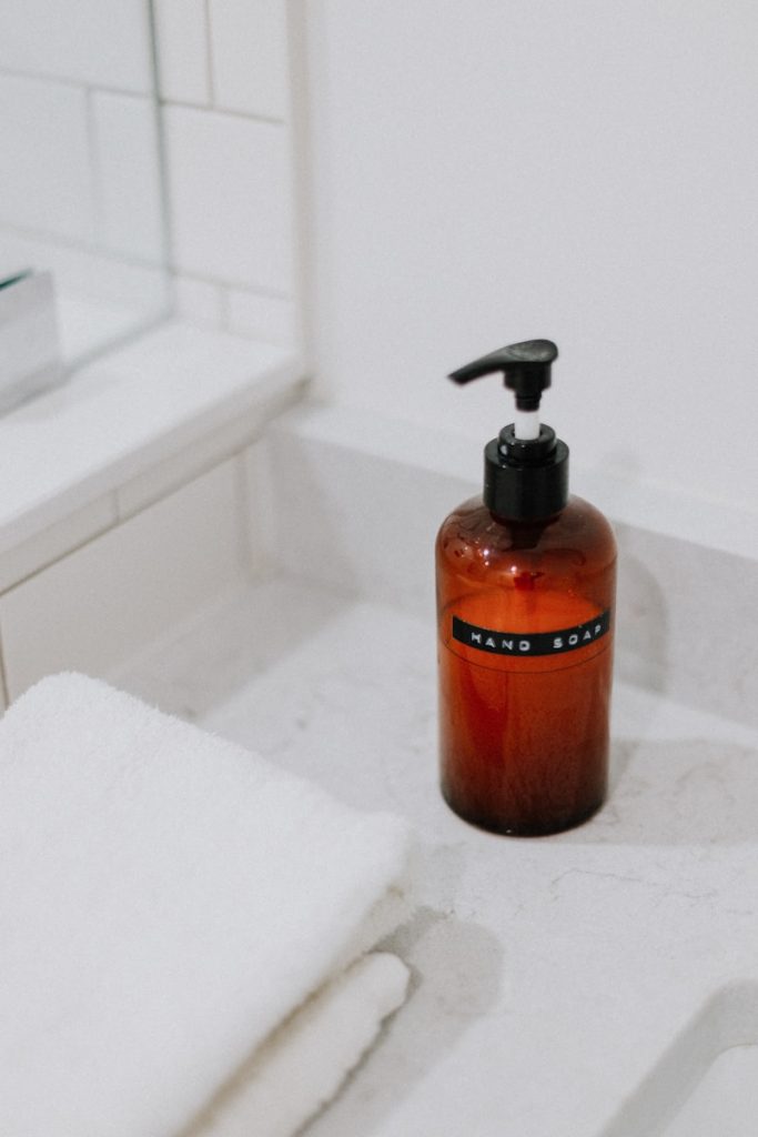 A bottle of soap sitting on a bathroom counter